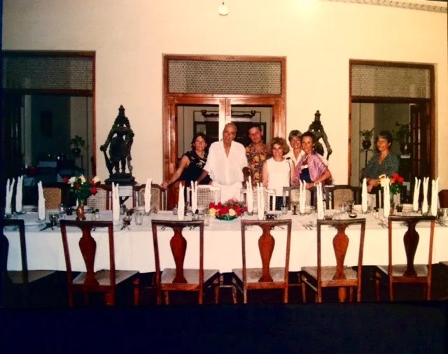 A group gathered around a table in an archival photograph