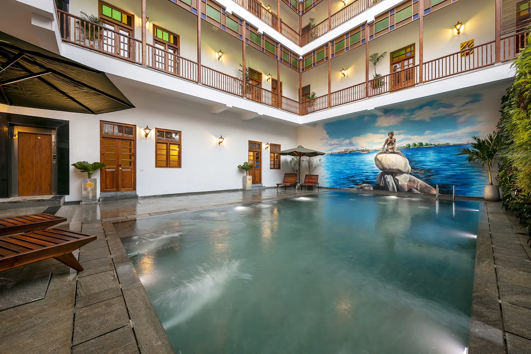 Hotel courtyard pool and surrounding balconies